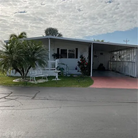 View of front of property featuring a carport