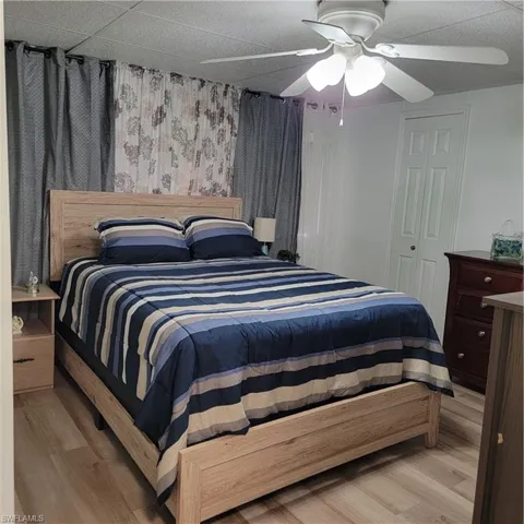 Bedroom with ceiling fan and light hardwood / wood-style flooring