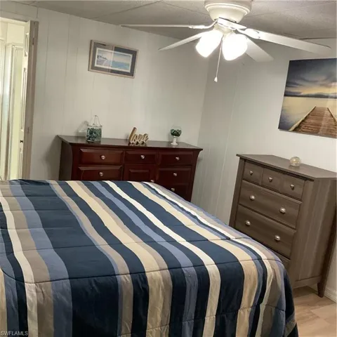 Bedroom with light hardwood / wood-style floors and ceiling fan
