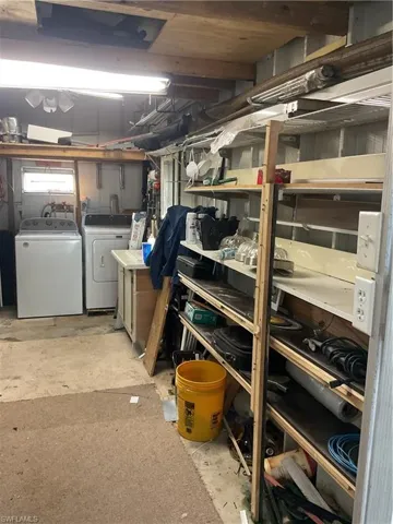 Storage area featuring washer and clothes dryer
