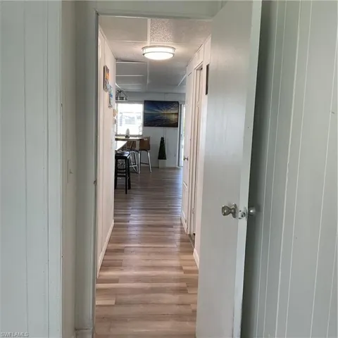 Hallway with light hardwood / wood-style flooring