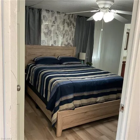 Bedroom featuring wood-type flooring and ceiling fan