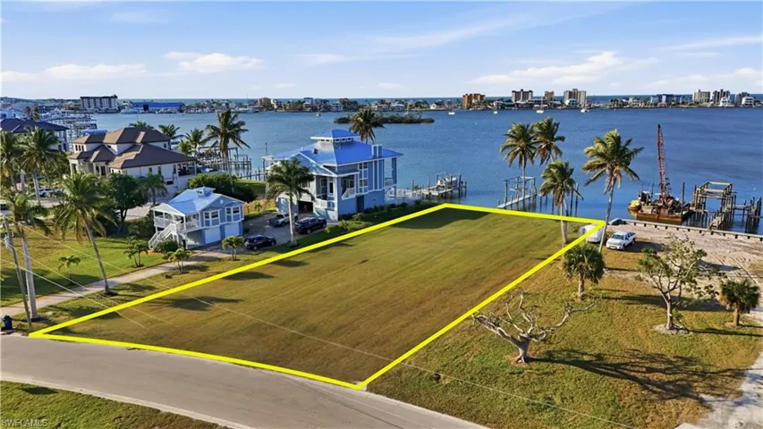 View of urban area with property parcel outlined and a nearby body of waterchange color of water into natural dark blue canal water