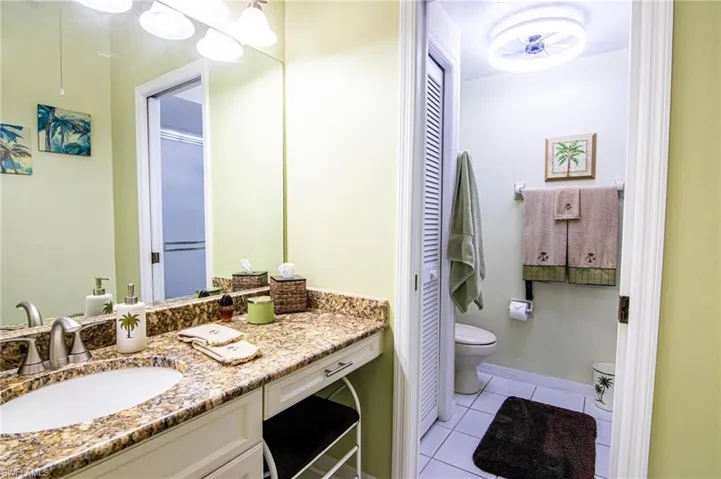 Bathroom featuring tile patterned floors, vanity, and toilet