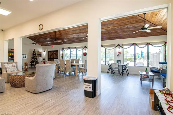 Living room with wood-type flooring, vaulted ceiling, ceiling fan, and wood ceiling