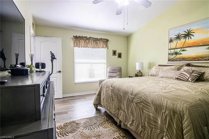 Bedroom featuring ceiling fan, light hardwood / wood-style flooring, and vaulted ceiling