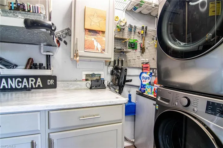 Laundry room featuring stacked washer / drying machine