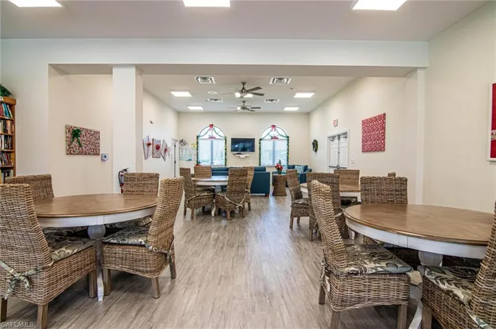 Dining space with ceiling fan and light wood-type flooring