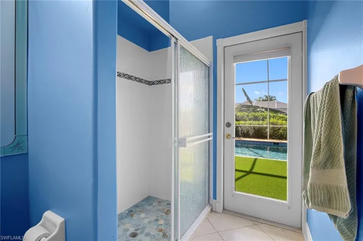 Doorway to outside featuring tile patterned flooring
