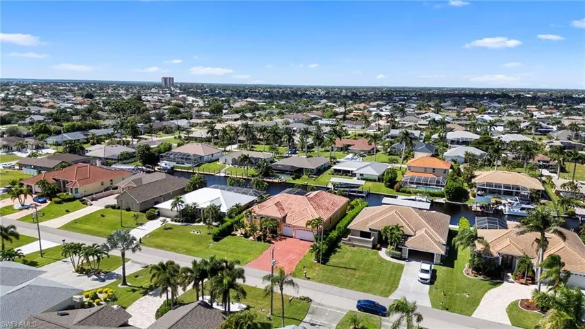 Aerial perspective of suburban area with a nearby body of water