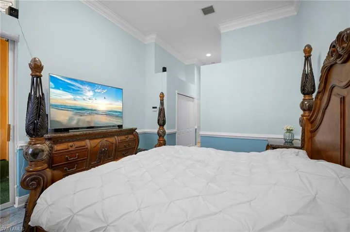 Bedroom with crown molding, a closet, and recessed lighting