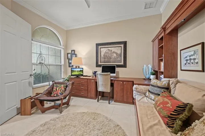 Office space with ornamental molding and light tile patterned floors