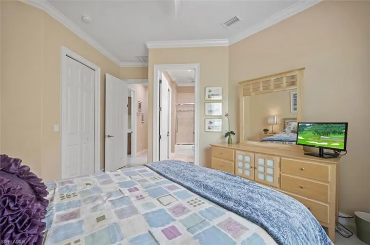Bedroom featuring crown molding and a closet