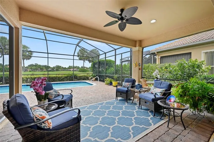 View of patio / terrace with an outdoor pool, a ceiling fan, and glass enclosure