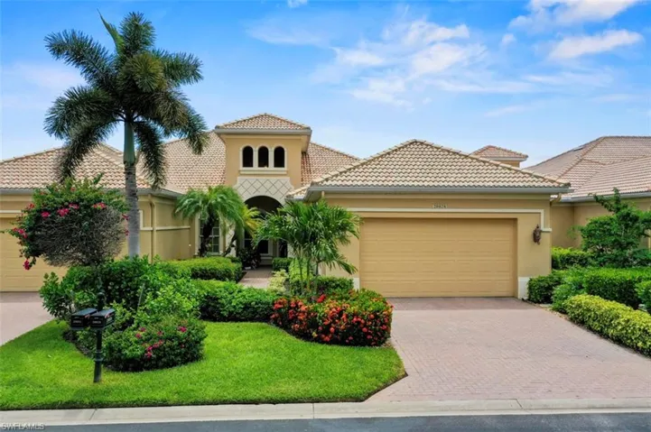Mediterranean / spanish-style home featuring an attached garage, decorative driveway, stucco siding, and a front yard