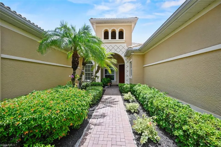 Entrance to property with stucco siding