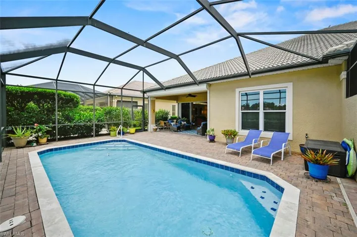 Swimming pool with a patio and ceiling fan