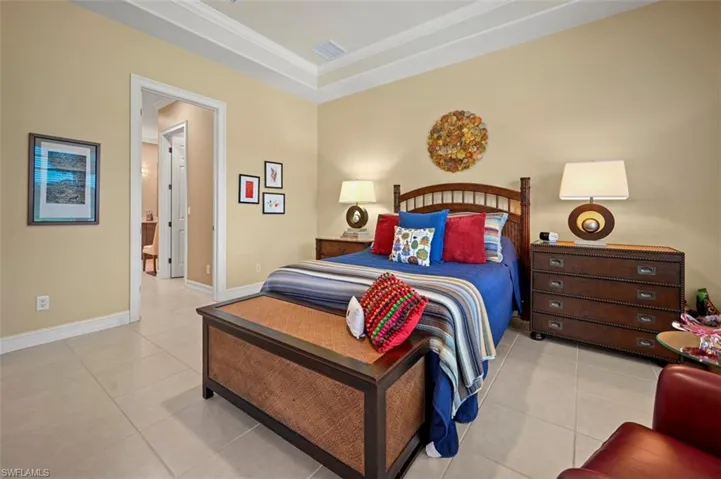Bedroom with light tile patterned flooring and ornamental molding