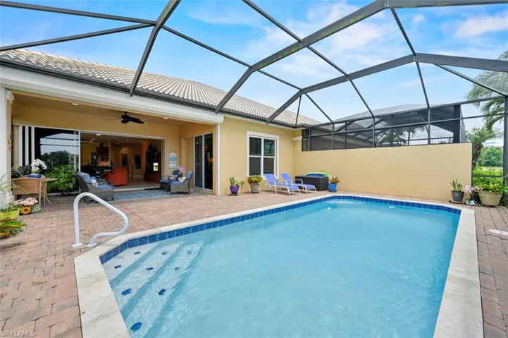 Outdoor pool with a patio and ceiling fan