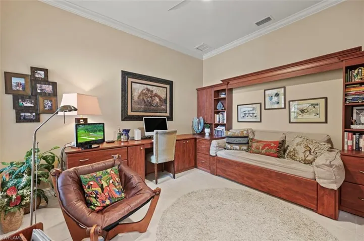 Office area with crown molding and light tile patterned floors