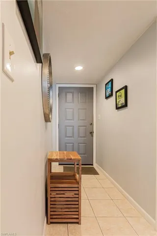 Doorway with light tile patterned floors