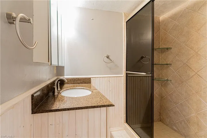 Bathroom featuring vanity and an enclosed shower