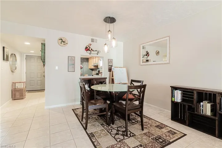 Dining space featuring light tile patterned floors