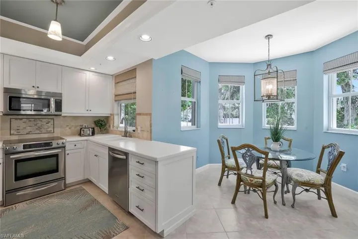 Kitchen with stainless steel appliances, a sink, baseboards, tasteful backsplash, and recessed lighting