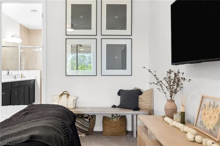 Spacious room featuring neutral carpeting and a wall-mounted display