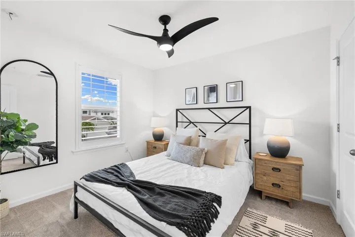 Interior space featuring white walls and a ceiling fan with integrated lighting