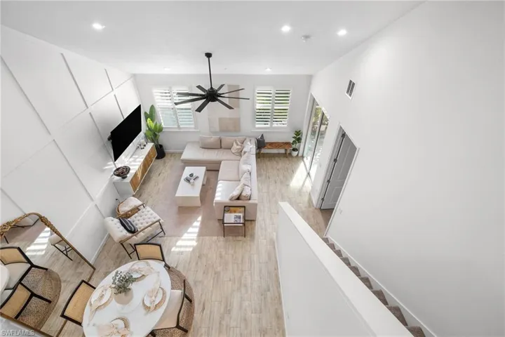 Expansive living area featuring soaring ceilings and wood-finish flooring