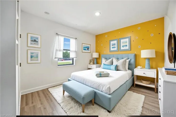 Bedroom featuring light wood-type flooring and an accent wall