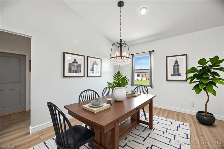 Dining room featuring light wood-style floors and lofted ceiling