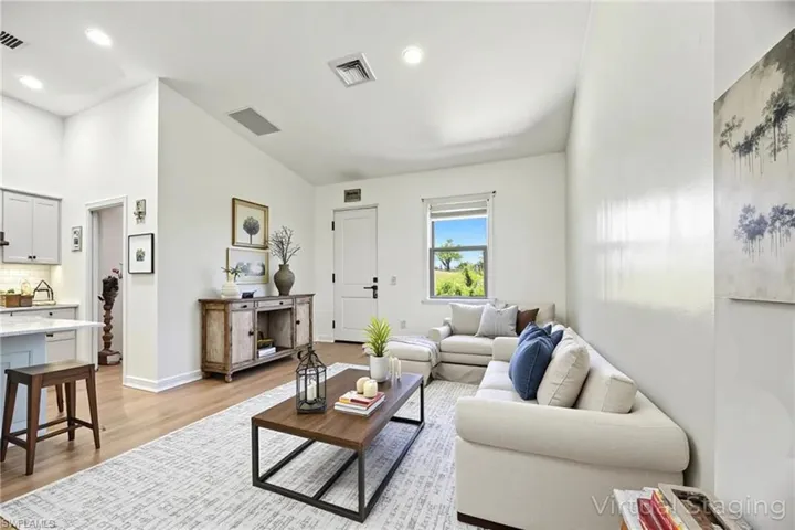 Living room featuring light wood-style flooring and recessed lighting