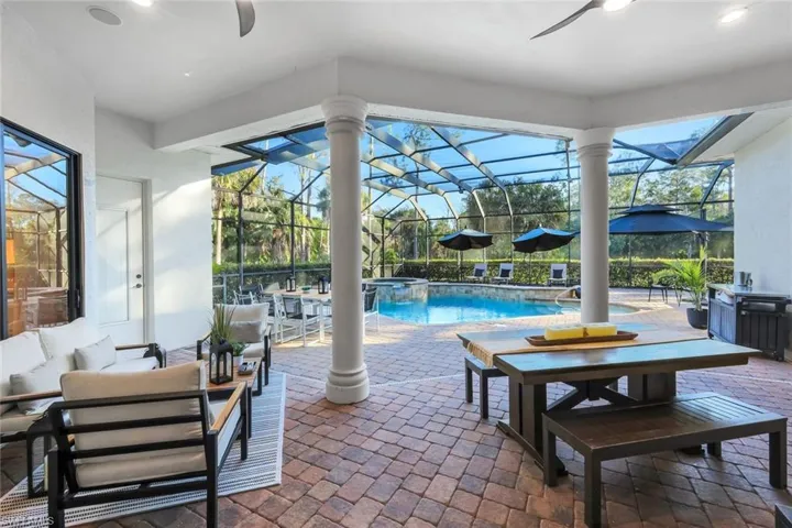 Integrated pool / spa featuring a patio area, glass enclosure, and a sunroom