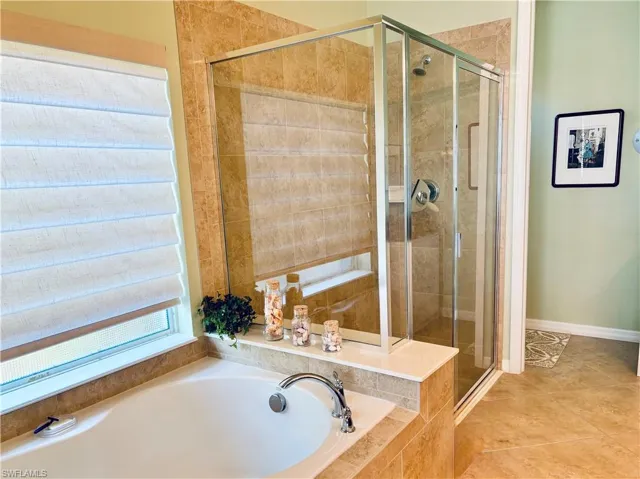 Bathroom with tile patterned flooring and plus walk in shower