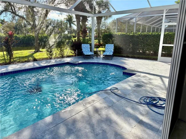 View of swimming pool with a lanai and a patio area
