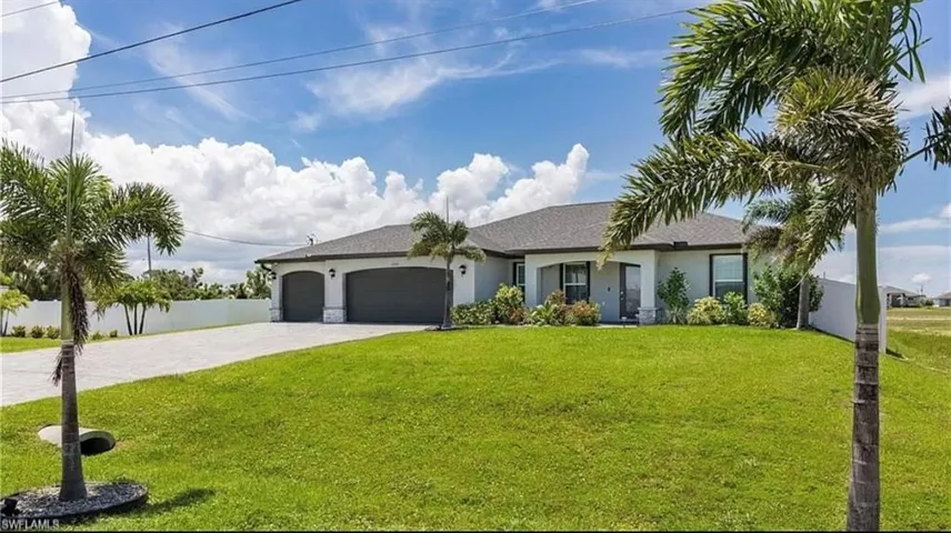Ranch-style house with a garage and a front yard