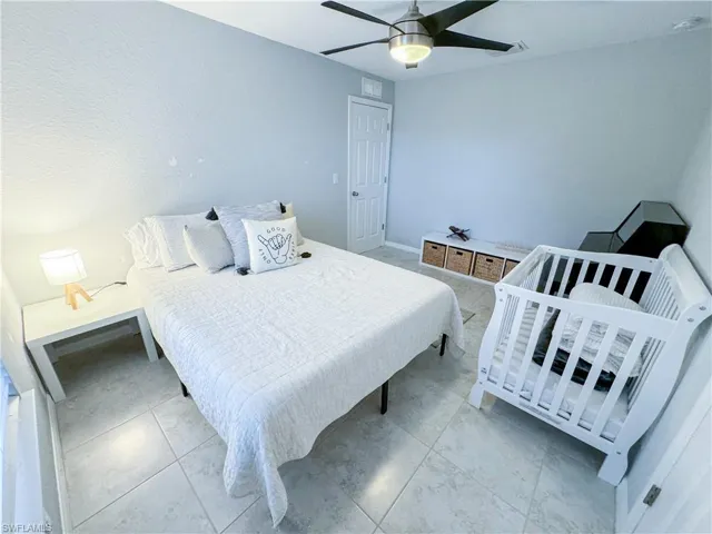 Bedroom featuring tile flooring and ceiling fan
