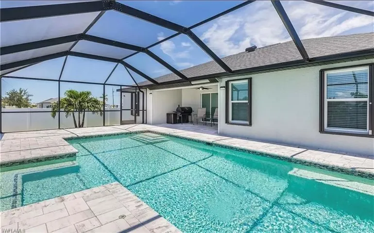 View of pool with a patio, a lanai, and ceiling fan