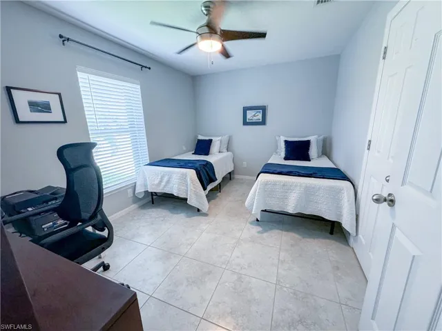 Bedroom featuring light tile patterned flooring and ceiling fan