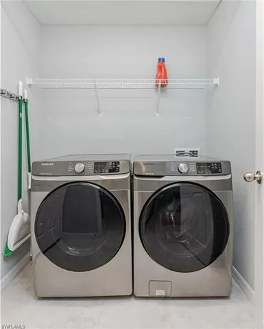 Clothes washing area featuring washing machine and dryer