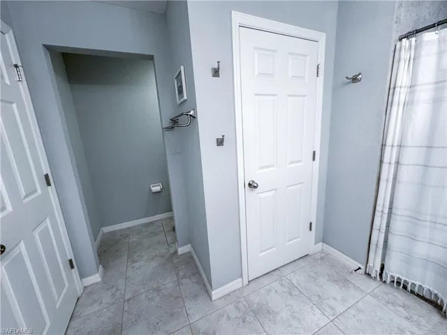 Hallway featuring light tile patterned flooring