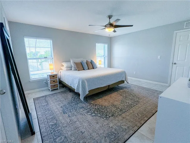 Bedroom featuring ceiling fan and tile patterned floors