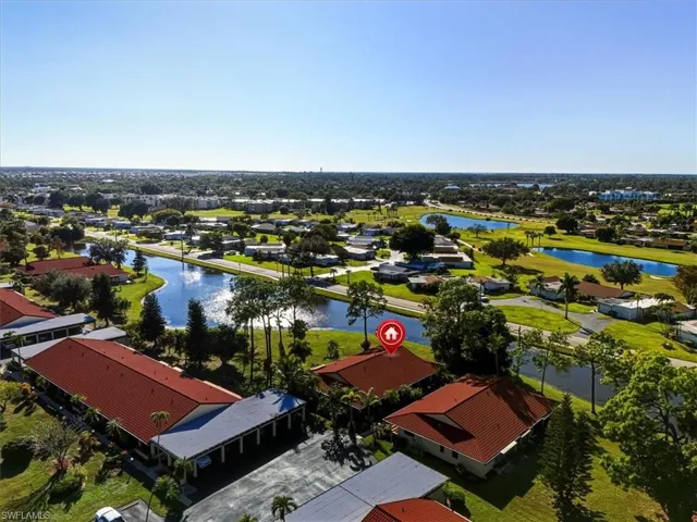 Aerial perspective of suburban area featuring a nearby body of water