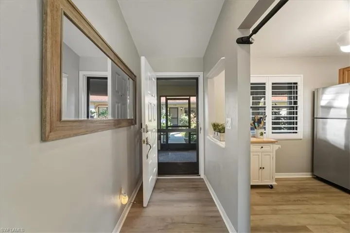 Hall featuring baseboards and light wood-style flooring