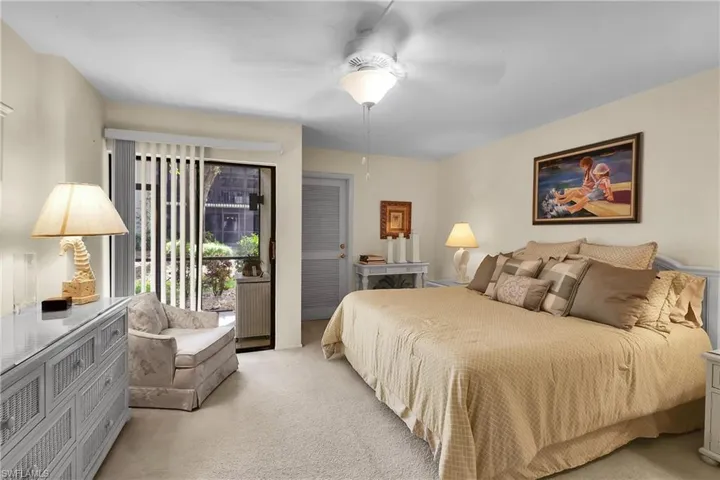 Bedroom with access to outside, carpet, and ceiling fan