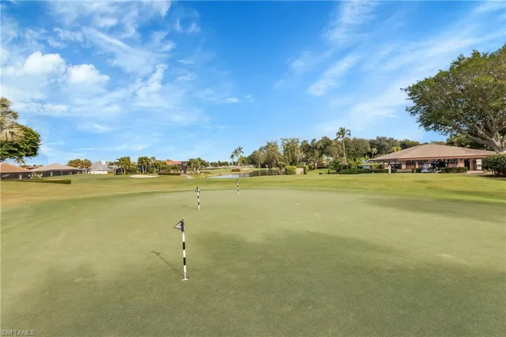 View of property's community featuring golf course view, a yard, and a water view