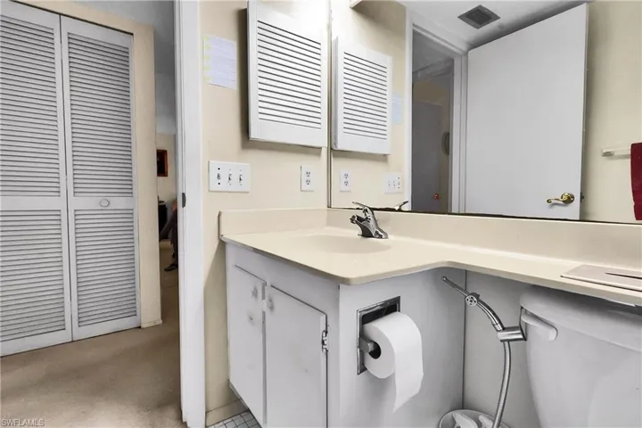 Half bath with a closet and vanity