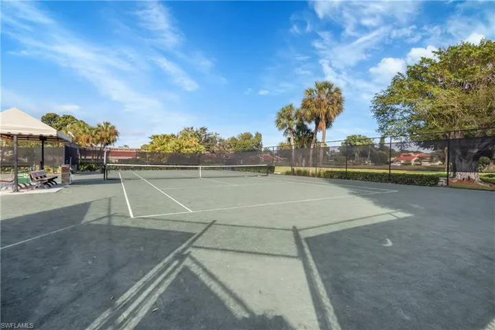 View of tennis court featuring community basketball court, a gazebo, and a patio